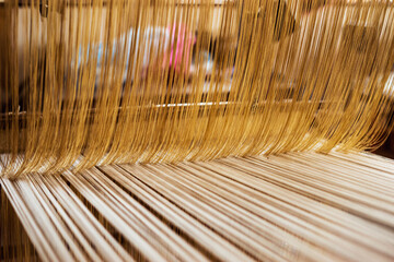 oriental traditional cloth making wooden equipment tools and technique creating pattern elegant cloth, using cotton and silk string stretch and woven by using mechanic wooden machine to weave