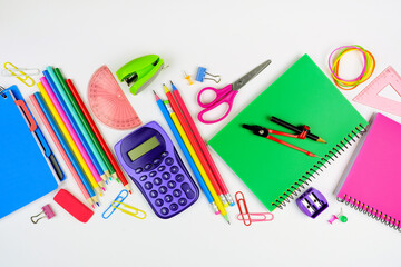 Wall Mural - School supplies scene. Flat lay over a white background. Back to school concept.