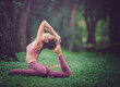 © NITIKAN T. - Asian model poses yoga in a park on a natural green background, health care concept, beautiful body structure, fit body