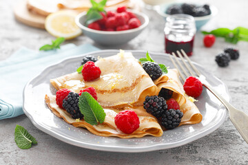 Poster - Thin crepes with fresh berries and lemon zest. Pancakes with raspberry and blackberry.