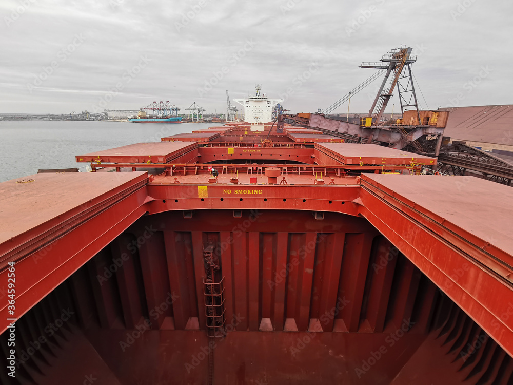 Foto Stok View of bulk carrier main deck with opened hatch-covers ...