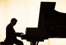 Silhouette Of Pianist Performing