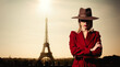 © Masson - girl in red coat and vintage hat with Parisian Eiffel tower on background.