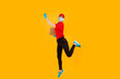 © Shopping King Louie - A cheerful, excited, Bouncing female courier in a red Cap and t-shirt, uniform, medical protective mask and gloves, with boxes in her hands, on a yellow background. coronavirus