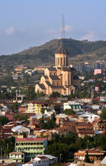 Wall Mural - Tsminda Sameba Church (The Holy Trinity Cathedral)  from Narikala Fortress in Tibilisi, Georgia.