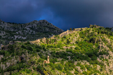 Poster - Catholic Church of Our Lady of Remedy on St John Mountain along Old Town city walls and stormy skies, Kotor, Montenegro