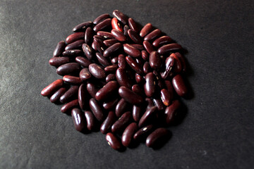 Wall Mural - Red kidney beans isolated on black background. Closeup of Multiple red kidney beans still-life display