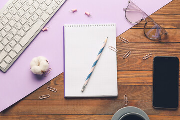 Composition with notebook and computer on color background