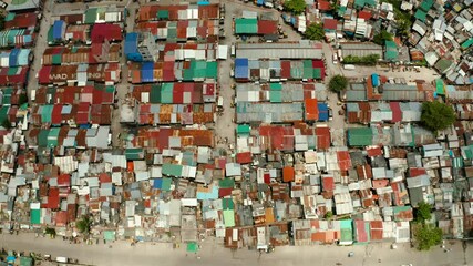 Wall Mural - Poor district and slums with shacks in a densely populated area of Manila aerial view.