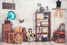 Vintage Travel Suitcases, Backpack, Old Gramophone, TV, Radio, Mic, Projector, Clock, Typewriter, Quill, Books, Camera, Teddy Bear, Toy Plane, Signboard, Mask. Antiques Collectibles. Retro Style Photo