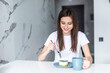© F8  \ Suport Ukraine - Young woman in her country kitchen with a coffee and cake