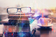 © peshkova - Financial graph hologram with glasses on the table background. Concept of business. Double exposure.