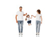 © LIGHTFIELD STUDIOS - happy parents holding hands of cute daughter jumping on white