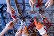 Many hands holding hand tools in the workshop. Labour day concept.