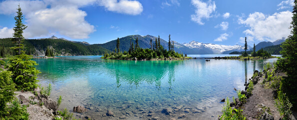 Wall Mural - Panoramic view of glacial mountain Garibaldi lake with turquoise water on sunny summer day.islands with firs in the middle of the lake.  Garibaldi provincial park near Whistler, BC, Canada.