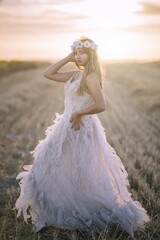 Poster - Caucasian beautiful brunette woman posing and wearing a white dress and white flower headband