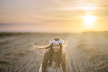 Sticker - Beautiful woman wearing a white dress, a white flower headband and smiling for the camera