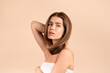 © Prostock-studio - Gorgeous young girl with smooth skin and silky long hair posing on beige background