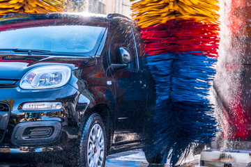 Wall Mural - Car going through an automated car wash machine