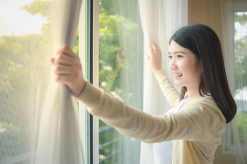 beautiful girls teenage open the house window in the morning holiday wearing yellow pajamas after wa