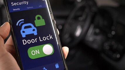 Locking and unlocking the doors of a car using a mobile phone application. Security smartphone app for the car concept.