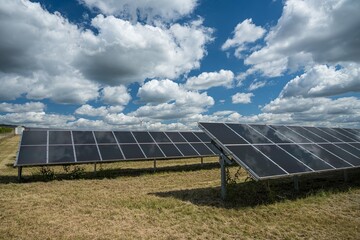 Wall Mural - Solar panels in the grain field in the countryside under the cloudy sky