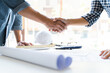 © mojo_cp - Engineer architecture team hands shaking together.