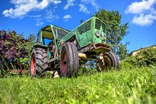 A German Vintage Tractor Stands On A Green Meadow