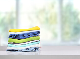 Wall Mural - Stack of colorful clothes on table empty copy space,cotton clothing pile.