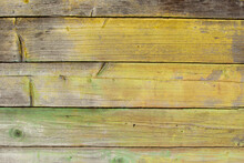 Old Tumbledown Weathered Wood Boards Background With Peeled Paint, Shabby Rustic Multicolored Barn Timbered Siding Aged Withered Faded Gray Surface.