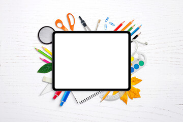 Poster - Tablet with isolated screen for mockup, app or website presentation surrounded by school supplies