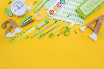 Office stationery on yellow background. Back to school concept. Flat lay, place for text.