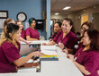 © Erik Isakson/Tetra Images - Nurses at reception desk