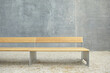 © Steve Korn/Tetra Images - Wooden modern bench against¬†concrete wall