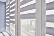 Windows with open modern horizontal blinds indoors, closeup