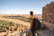 © sebastiancaptures - Woman looking at view while standing on old ruin against clear sky