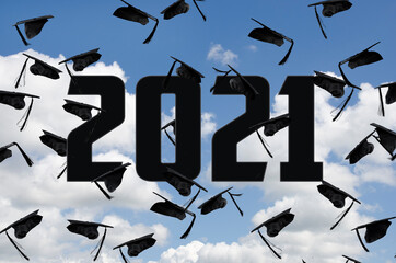 Canvas Print - black graduation caps in sky with clouds and 2021 text