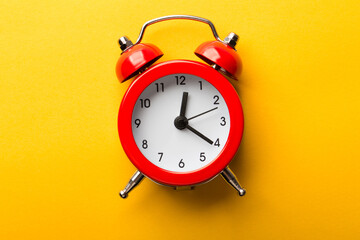 Wall Mural - Clock Isolated On Yellow Background