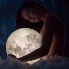 Wall Mural - female tenderness, a beautiful girl holds the moon against the background of stars and sky, zodiac a