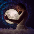 © Anton - Delicate photography, Astrology, Women's magic. Beautiful attractive girl on the background of the universe and the stars hugs the moon in the clouds, art photography, femininity