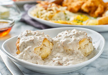 Biscuits And Gravy With Sausage On Plate