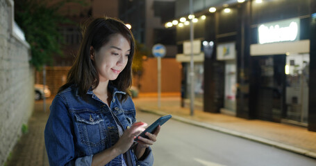 Poster - Young woman use of mobile phone at night