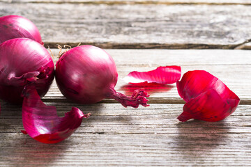 Wall Mural - spanish onions on old rustic wood table background