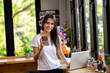 © PK Studio - Asian woman or a happy student smiles on a desk with a computer.