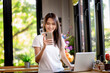 © PK Studio - Asian woman or a happy student smiles on a desk with a computer.