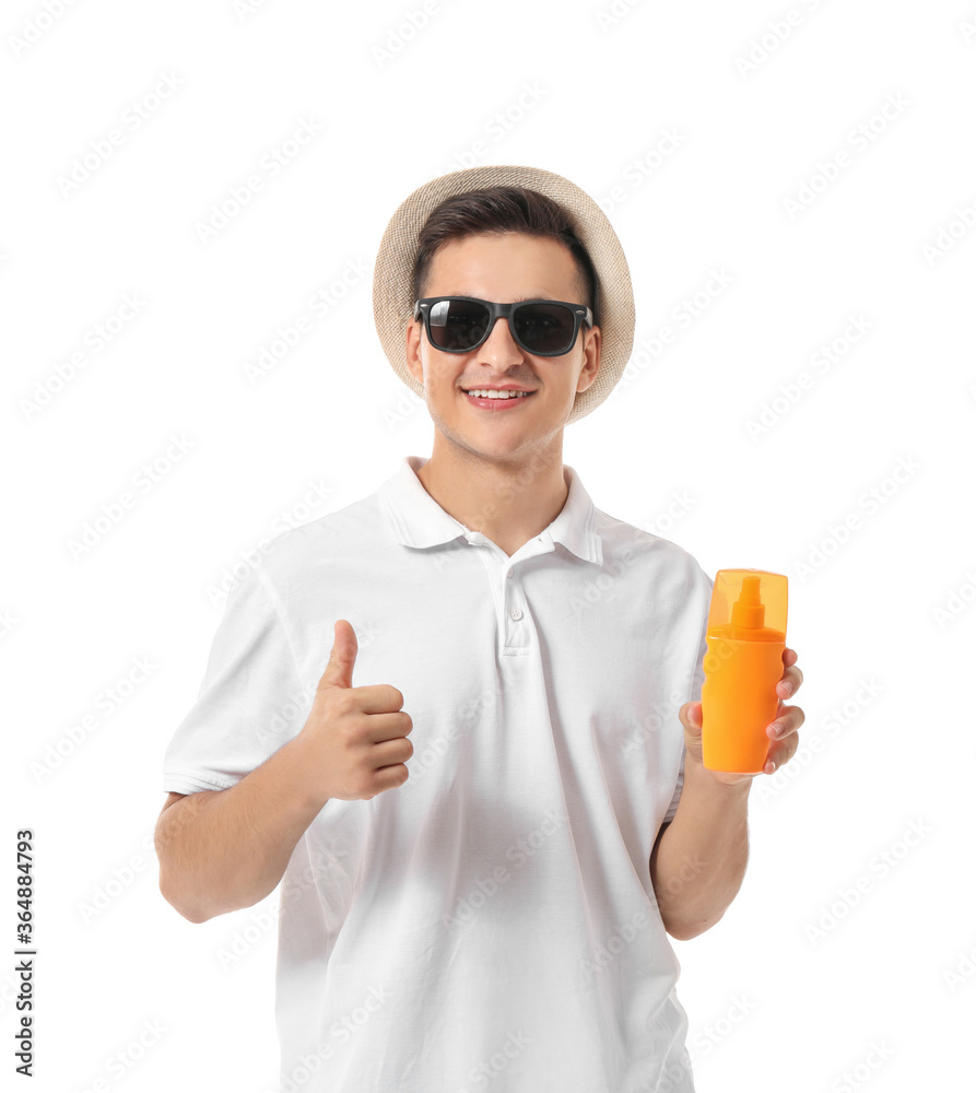 Happy young man with sun protection cream on white background