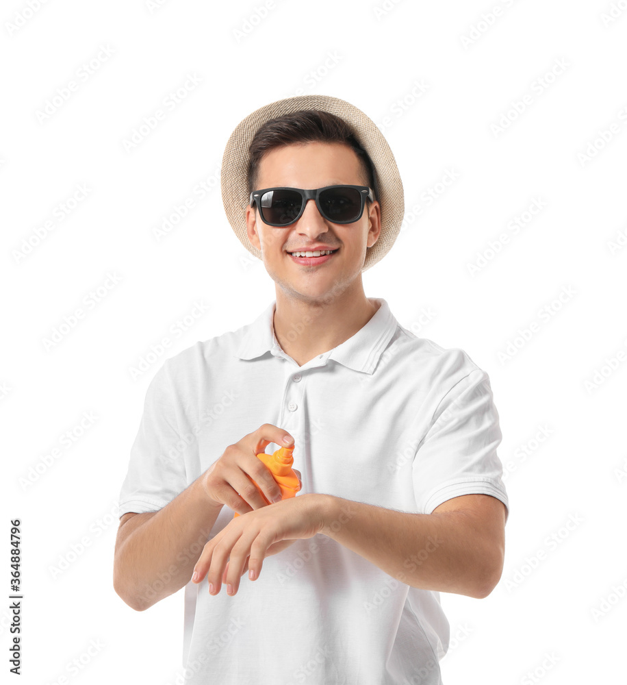 Happy young man with sun protection cream on white background