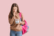 © Pixel-Shot - Teenage girl with savings for education on color background