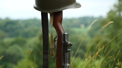 Wall Mural - Memorial battlefield cross. Symbol of a fallen US soldier. M1 rifle with helmet.