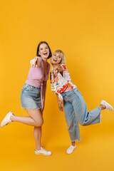 Sticker - Portrait of two cheerful lovely girlfriends standing